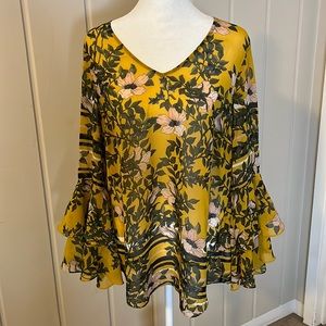 Beautiful flowy mustard yellow floral Cabi Blouse in a women’s medium.
